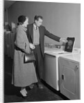 Young couple man woman shopping for washing machine by Anonymous