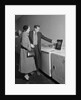 Young couple man woman shopping for washing machine by Anonymous