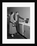 Young couple man woman shopping for washing machine by Anonymous