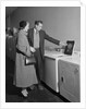 Young couple man woman shopping for washing machine by Anonymous