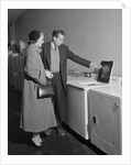 Young couple man woman shopping for washing machine by Anonymous
