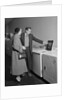 Young couple man woman shopping for washing machine by Anonymous