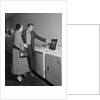 Young couple man woman shopping for washing machine by Anonymous