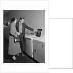 Young couple man woman shopping for washing machine by Anonymous
