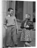 Smiling boy & girl holding school books by doors by Anonymous