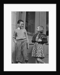 Smiling boy & girl holding school books by doors by Anonymous
