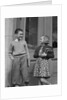 Smiling boy & girl holding school books by doors by Anonymous