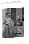Smiling boy & girl holding school books by doors by Anonymous