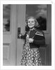 Smiling girl print dress holding school books opening door by Anonymous