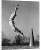 Male cheerleader jumping cheering megaphone on ground by Anonymous