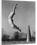 Male cheerleader jumping cheering megaphone on ground by Anonymous