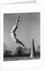 Male cheerleader jumping cheering megaphone on ground by Anonymous