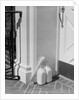 Glass milk bottles and newspaper by front door home delivery by Anonymous