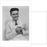 Smiling curly hair man wearing apron taking order with pencil and note pad by Anonymous