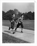 Two smiling boys running carrying school books by Anonymous