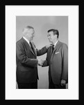 Older and younger business men shaking hands by Anonymous