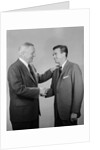 Older and younger business men shaking hands by Anonymous