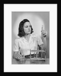 Young woman chemist holding up test tube by Anonymous