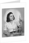 Young woman chemist holding up test tube by Anonymous