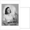 Young woman chemist holding up test tube by Anonymous