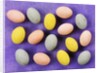 Small coloured Easter eggs on purple background by Anonymous