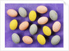 Small coloured Easter eggs on purple background by Anonymous