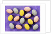 Small coloured Easter eggs on purple background by Anonymous
