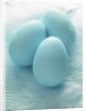 Three blue Easter eggs on feathers by Anonymous