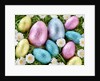 Chocolate Easter eggs in coloured foil in grass by Anonymous