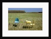 Abandoned school desk and chairs in farmer's field by Anonymous