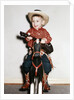 Little boy cowboy plays guitar while riding his horse, ca. 1956 by Anonymous