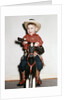 Little boy cowboy plays guitar while riding his horse, ca. 1956 by Anonymous