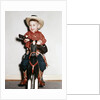 Little boy cowboy plays guitar while riding his horse, ca. 1956 by Anonymous