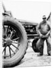 Farmer is a blur of activity working on his tractor, ca. 1938 by Anonymous