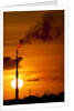 Flames and smoke billow from natural gas flare at Valero Oil Refinery at sunset by Anonymous