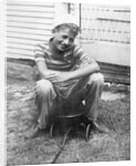 Boy sitting a very small wagon, ca. 1938 by Anonymous