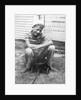 Boy sitting a very small wagon, ca. 1938 by Anonymous