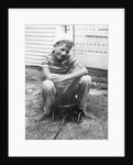 Boy sitting a very small wagon, ca. 1938 by Anonymous