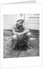 Boy sitting a very small wagon, ca. 1938 by Anonymous