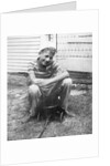 Boy sitting a very small wagon, ca. 1938 by Anonymous