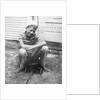 Boy sitting a very small wagon, ca. 1938 by Anonymous