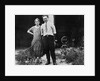 Young couple stands in front of their garage, ca. 1925 by Anonymous