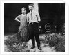 Young couple stands in front of their garage, ca. 1925 by Anonymous