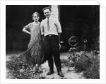 Young couple stands in front of their garage, ca. 1925 by Anonymous