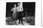 Young couple stands in front of their garage, ca. 1925 by Anonymous