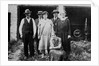 Family standing in front of garage, ca. 1925 by Anonymous
