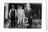 Family standing in front of garage, ca. 1925 by Anonymous