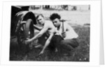 Young men change a tire on an automobile, ca. 1918 by Corbis