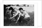 Young men change a tire on an automobile, ca. 1918 by Anonymous