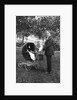 Woman in men's' clothes with a stroller at a baby shower, ca. 1924 by Anonymous